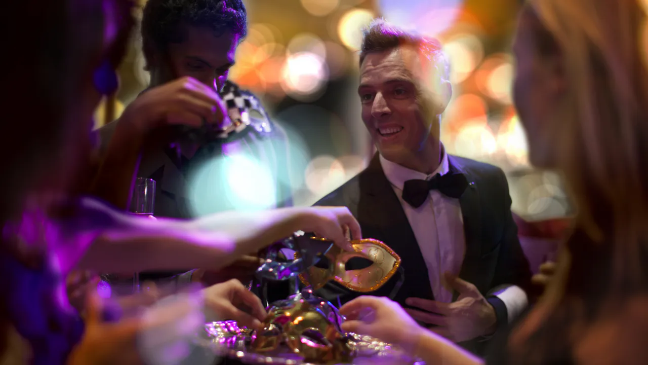 Mehrere formell gekleidete Personen halten Masken bei einer festlichen Veranstaltung, mit bunten, verschwommenen Lichtern im Hintergrund - eine Szene, wie du eine Casino-Nacht zum Geburtstag organisierst.